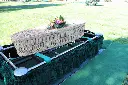 willow casket on stand in cemetery yard.webp